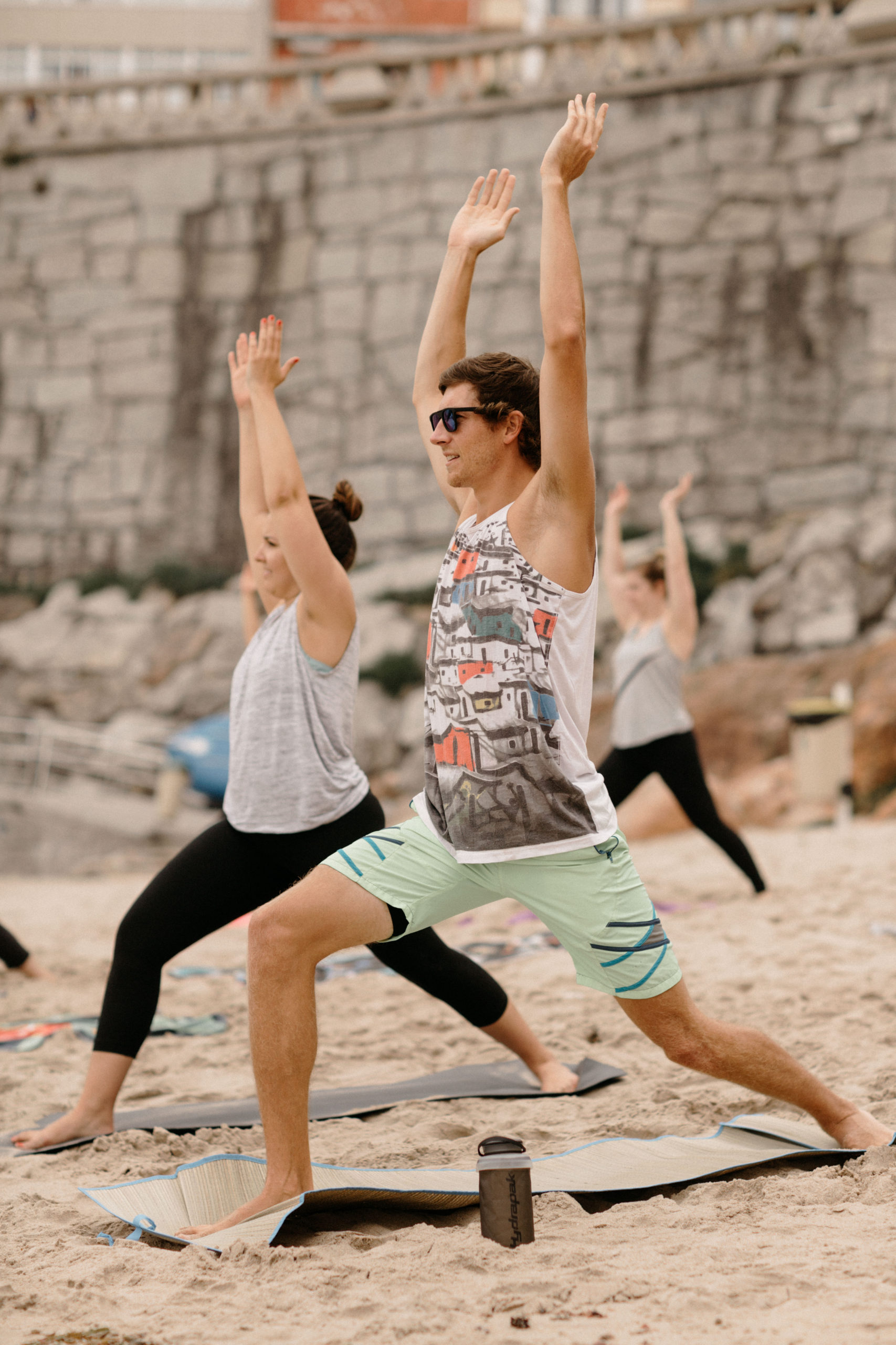 Beach yoga class Warrior I pose