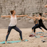 Beach yoga warrior 2 pose