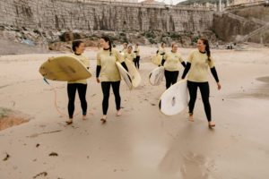 Girls heading out to surf in A Coruna, Spain